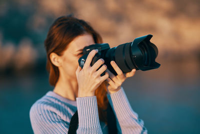 Portrait of woman photographing