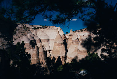 Low angle view of rock formations against sky