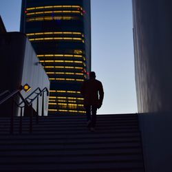 Low angle view of man on staircase against building