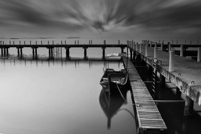 Wooden pier over sea against sky