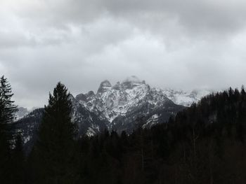 Scenic view of mountains against cloudy sky