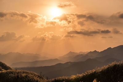 Scenic view of silhouette mountains against sky during sunset