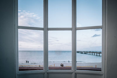 Scenic view of sea seen through glass window