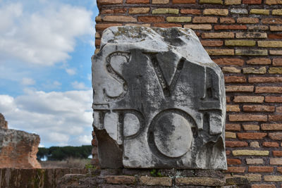 View of old stone wall against cloudy sky