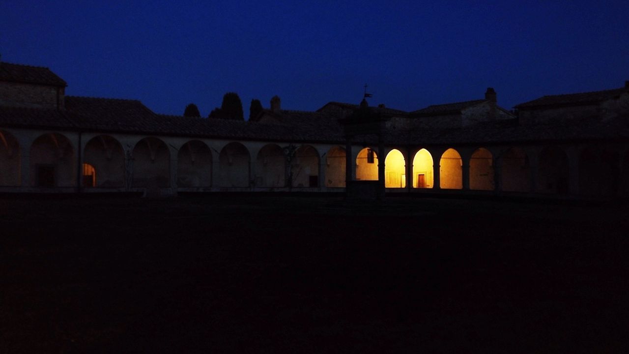 architecture, illuminated, built structure, night, building exterior, clear sky, arch, copy space, dark, blue, silhouette, architectural column, dusk, sky, in a row, outdoors, sunset, history, travel destinations, lighting equipment