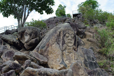 Low angle view of statue against rock formation