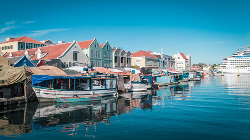 Boats moored at harbor