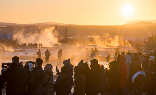 Group of people enjoying at sunset