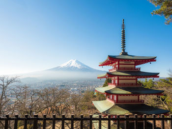 Red pagoda and fuji mountain background with beautiful sky from japan