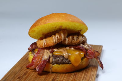 Close-up of burger against white background