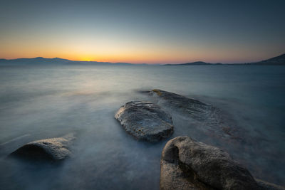 Scenic view of sea against sky at sunset