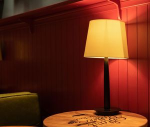 Illuminated lamp on table at home