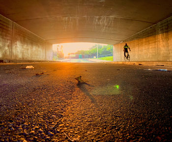 Man walking in city during sunset