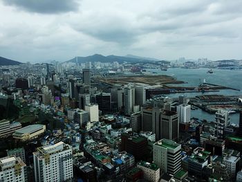 High angle view of cityscape against cloudy sky