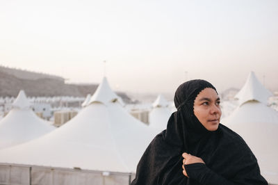 Portrait of woman in hijab standing in mecca