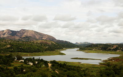 Scenic view of lake and mountains against sky