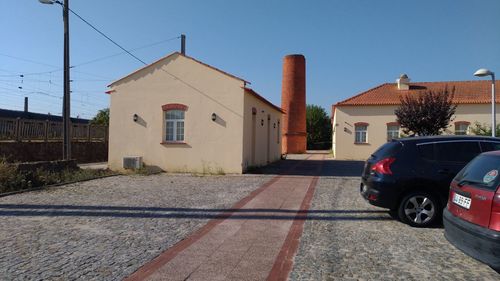 Car on street by buildings against clear sky