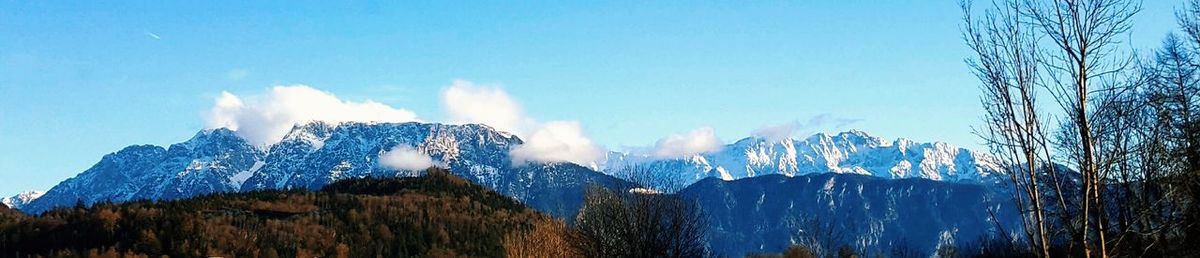 Panoramic view of mountains against clear blue sky