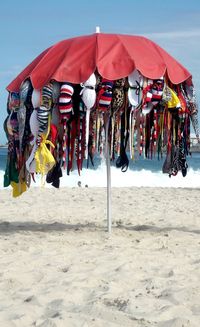 Multi colored umbrellas on beach against sky