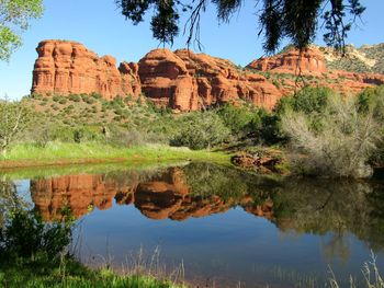 Reflection of red rock in lake water