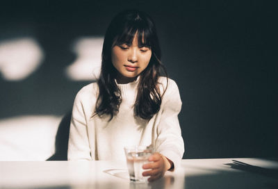 Young woman sitting on table