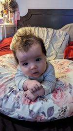 Portrait of cute baby boy sleeping on bed at home