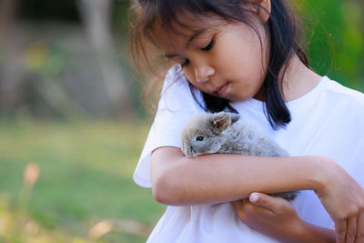 Close-up of young woman holding rabbit