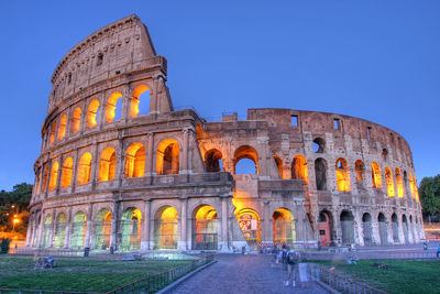 Illuminated coliseum against clear sky