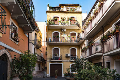 View of a beautiful town of taormina in sicily. architecture of buildings with planted plants