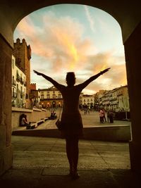 Silhouette of woman against clear sky at sunset