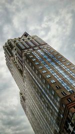 Low angle view of building against cloudy sky