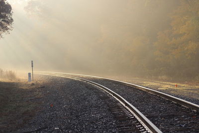 Empty railroad track during foggy weather