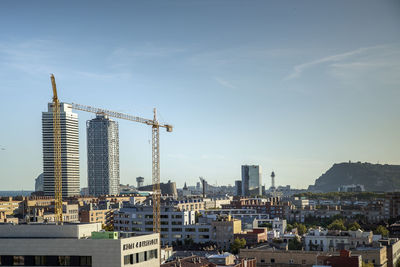 Modern buildings in city against sky