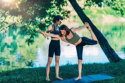 Yoga women by the water. dancer pose