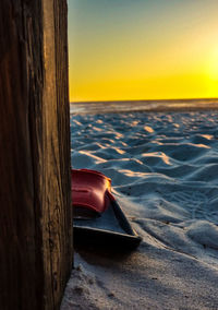 Close-up of sea against clear sky during sunset