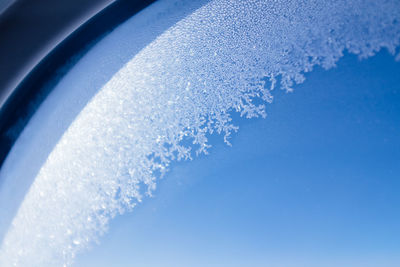 Low angle view of frost on window