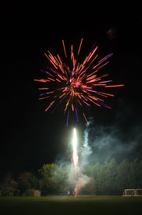 Low angle view of firework display at night