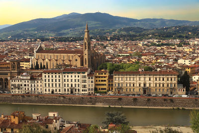 River amidst buildings in town against sky