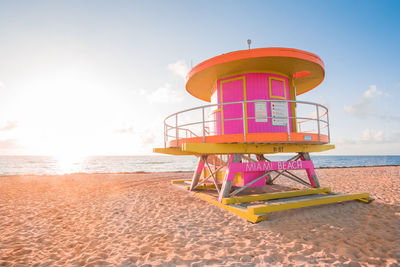 Lifeguard hut on beach against sky