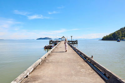 A woman standing on cement pier along over the sea at mu ko phetra in thailand