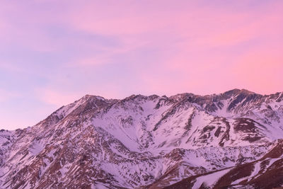 Scenic view of snowcapped mountains against pink sky during sunset