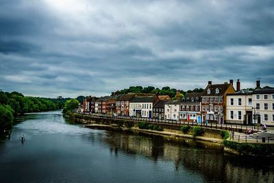 River amidst buildings against sky in city