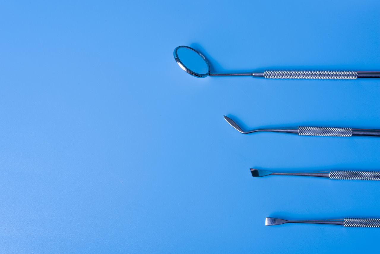 LOW ANGLE VIEW OF BLUE METAL AGAINST CLEAR SKY