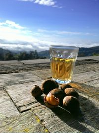 Close-up of cocktail in glass on table against mountain