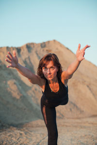 Mature woman exercising on beach