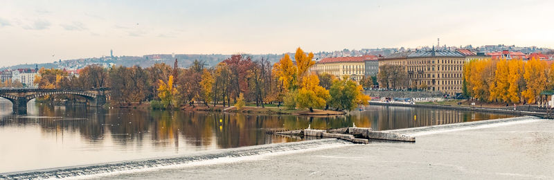 Bridge over river against sky during autumn