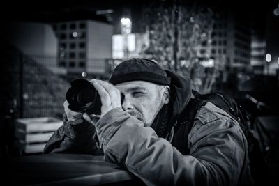 Man photographing in city