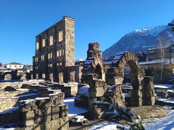 Ruins of old roman theatre in aosta city with snow