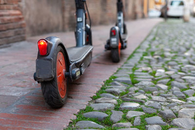 Two electric scooter parked on a footpath in the city center, modena, italy