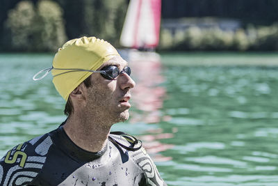 Close-up of man wearing swimming goggles in sea